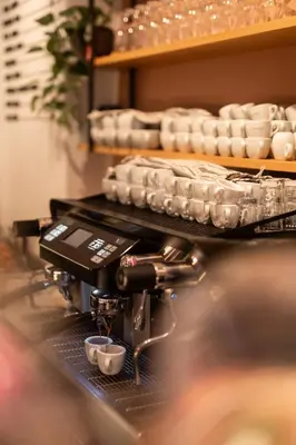 a coffee machine with two cups on a counter at Kuntino Suites in Merano