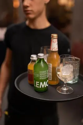 a tray with bottles of beer and a glass at Kuntino Suites in Merano