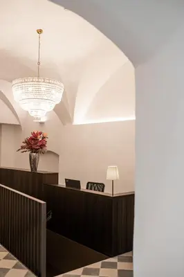 a view of a waiting room with a chandelier at Kuntino Suites in Merano