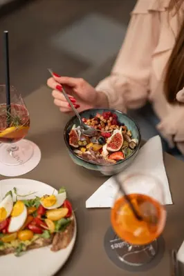 a table with a bowl of food and a bowl of salad at Kuntino Suites in Merano