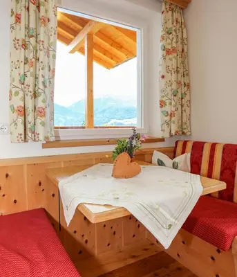 a small room with a table and a window at Bio Kräuterhof Oberpalwitter in Barbiano