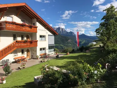 a view of a hotel with mountains in the background at Bio Kräuterhof Oberpalwitter in Barbiano