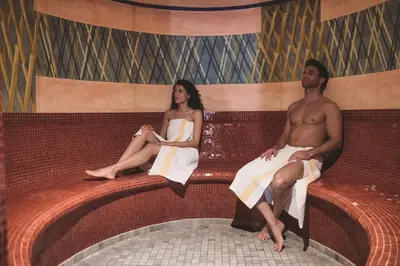 a man and a woman sitting on the back of a tub at Hotel Gasthof Stern in Nova Ponente