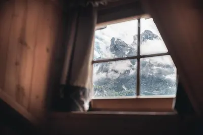 a window with a view of a mountain at Ciasa Altonn in Colfosco