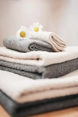 a stack of towels with flowers on top of them at Ciasa Altonn in Colfosco