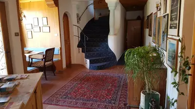 a hallway with a spiral staircase with a rug at Apartments Garni Steffi in Fiè