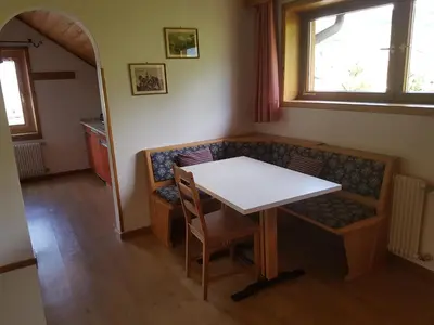 a dining room with a table and a couch at Apartments Garni Steffi in Fiè