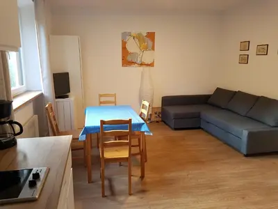 a living room with a blue table and a couch at Apartments Garni Steffi in Fiè