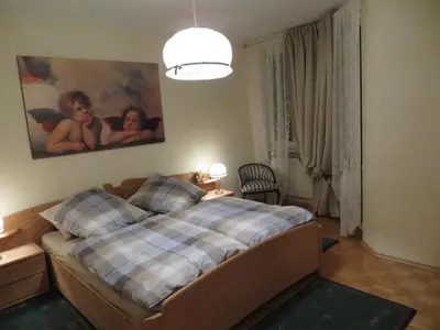 a bedroom with a bed with a checkered blanket at Casa Mia in Vadena