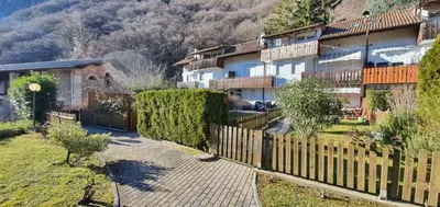 a house with a wooden fence in a village at Casa Mia in Vadena