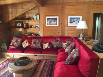 a red couch sitting in a living room at La casa dei cuori in Santa Cristina in Val Gardena