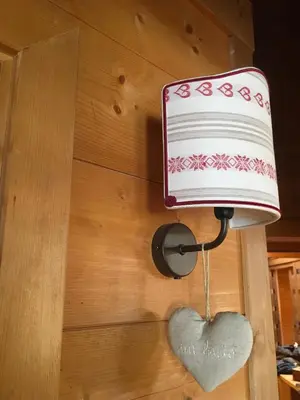 a lamp with a heart attached to a wall at La casa dei cuori in Santa Cristina in Val Gardena