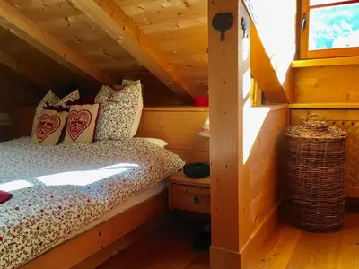 a bedroom with a bed in a log cabin at La casa dei cuori in Santa Cristina in Val Gardena