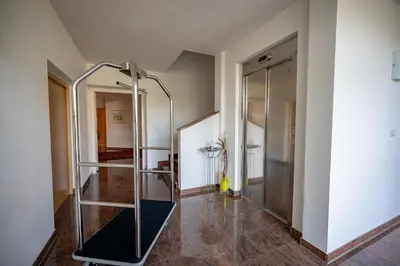 a glass shower in a room with a hallway at Garni Hotel Peterlinhof in Caldaro