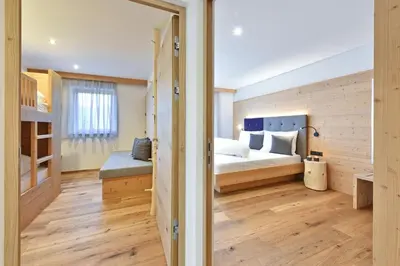 a bedroom with a bed and a bunk room at Forchnerhof Panorama- Rienzschlucht in Rodengo