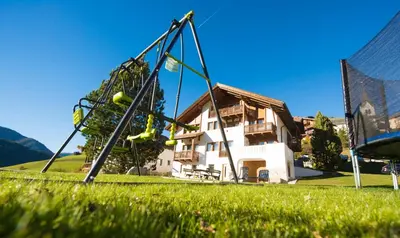 a swing set in front of a house at Apartments Tino in La Valle