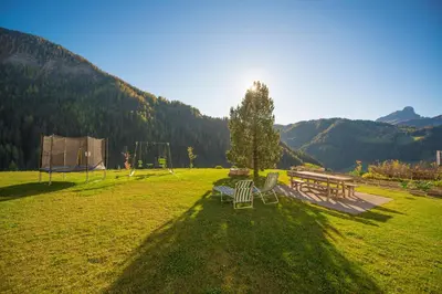 a park with a picnic table and benches in the grass at Apartments Tino in La Valle