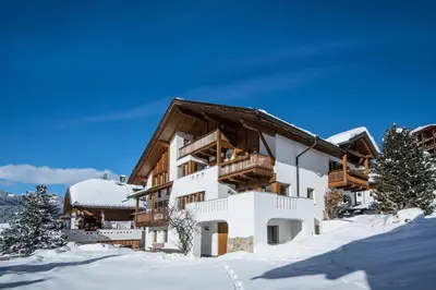 a ski lodge in the snow with snow at Apartments Tino in La Valle