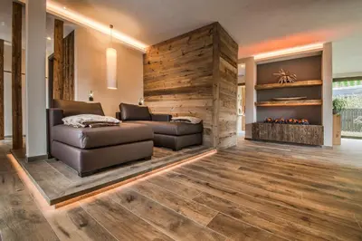 a living room with a couch and a fireplace at Hotel Restaurant Kirchsteiger in Vollan