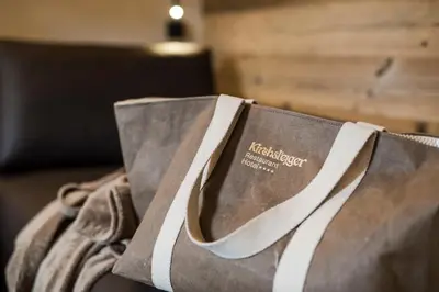 a brown shopping bag sitting on top of a couch at Hotel Restaurant Kirchsteiger in Vollan