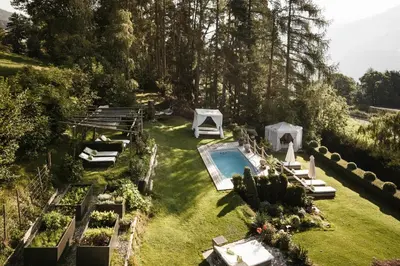 an aerial view of a garden with a swimming pool at Boutique Pension Erlacher - Adults Only in Villandro
