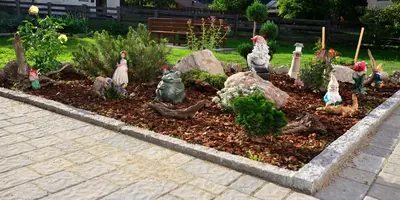 a garden with statues of chickens in a yard at Haus Cosso in Villabassa