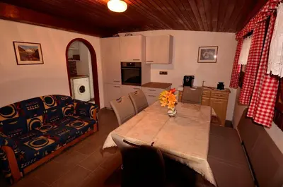 a kitchen and dining room with a table and a couch at Haus Cosso in Villabassa