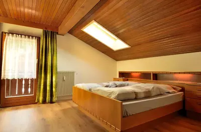 a bedroom with a bed and a large window at Haus Cosso in Villabassa