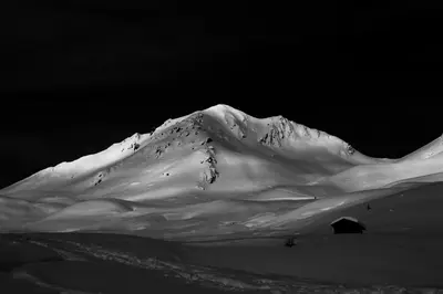 a snow covered mountain with a tent in front of it at Haus Cosso in Villabassa