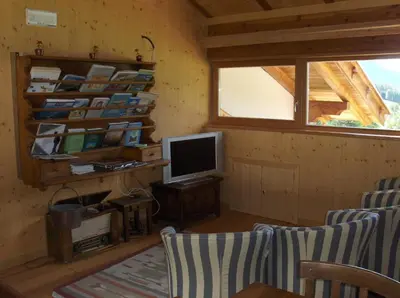 a room with a tv and a desk with a computer at B&B Affittacamere Larix in Rumo