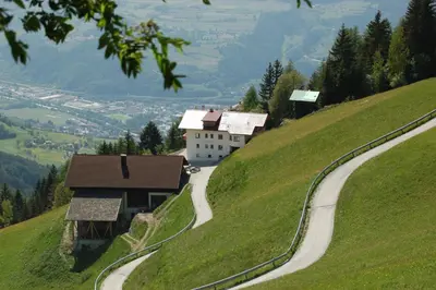 a house on the side of a hill with a road at Kaserhof wandern- Alleinlage - ruhig- top Aussicht in Bressanone