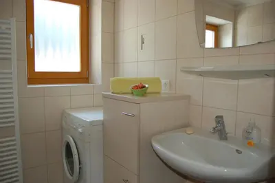 a bathroom with a sink and a washing machine at Kaserhof wandern- Alleinlage - ruhig- top Aussicht in Bressanone