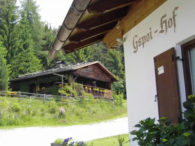 a building with a log house in the background at Gspoi-Hof in Laion