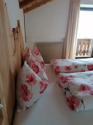 a room with two pillows on a bed with a window at Gspoi-Hof in Laion