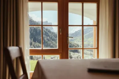 an open window with a view of a mountain at Refugium LaFlu Apartments in Corvara in Badia