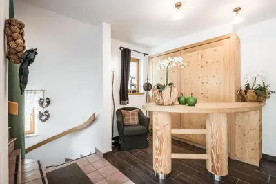 a dining room with a table and a chair at Residence Floralp in Colfosco