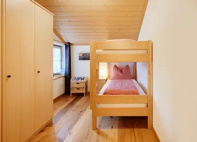 two beds in a room with wooden ceilings at Dosserhof in Fiè