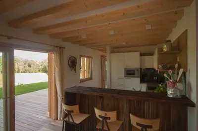 a kitchen with a counter and chairs in a room at Dosserhof in Fiè