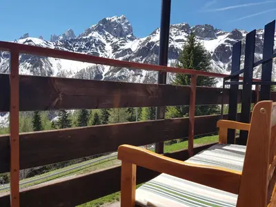 a balcony with a view of a snow covered mountain at Casa Mowgli - Residence Sussy in Falcade
