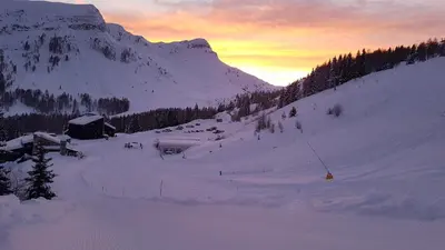 a snow covered mountain with a cabin on a snow covered slope at Casa Mowgli - Residence Sussy in Falcade