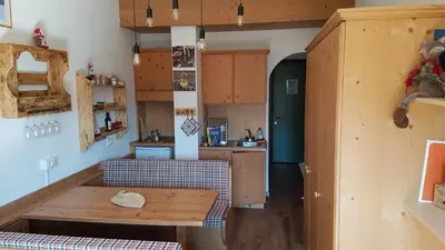 a kitchen with a wooden table in a room at Casa Mowgli - Residence Sussy in Falcade