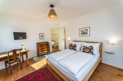 a bedroom with a bed and a desk and a television at Apartment Le rose di Marianne - sud in Varna