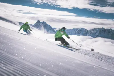 two people are skiing down a snow covered slope at Apartment Le rose di Marianne - sud in Varna
