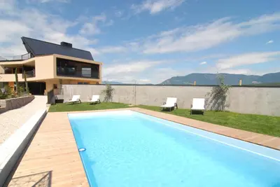 a swimming pool in the backyard of a house at Biobauernhof St. Quirinus in Caldaro