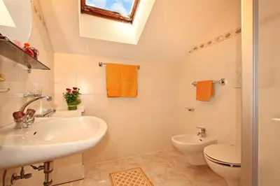 a bathroom with a sink and a toilet at Schmözlhof in Tesido