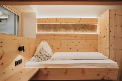 a bedroom in a tiny house at Untermathonhof Vöran - Ferienwohnungen - Urlaub am Bauernhof in Südtirol mit hofeigenem Frühstück in Verano