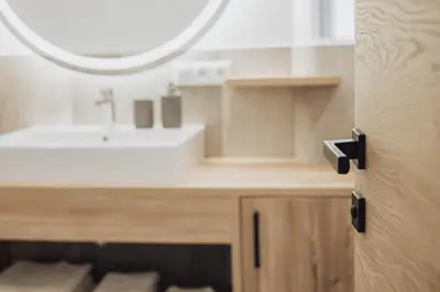 a bathroom with a sink and a mirror at Untermathonhof Vöran - Ferienwohnungen - Urlaub am Bauernhof in Südtirol mit hofeigenem Frühstück in Verano