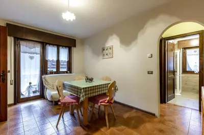 a dining room with a table and chairs at Des Alpes 2 in Canazei