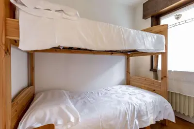 a bedroom with two bunk beds in a room at Des Alpes 2 in Canazei