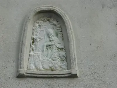 a stone statue on the side of a building at Plonerhof in Lagundo